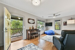 Front door, piano, bean bag and trees in your south & west-facing windows