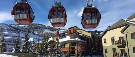 Enjoy a premier ski in ski out location -- gondola and slope in foreground, property in directly behind