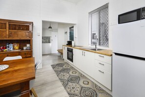 Fully equipped kitchen with full-size fridge/freezer, oven, stovetop, microwave, coffee machine and more