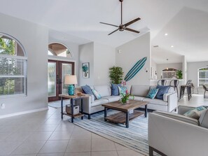 Coastal cool meets casual elegance—this open-concept living space brings the beach indoors