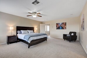 King size bed in the master with night stands and sitting chair