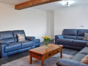 Delightful beamed living room with leather furniture | Pistyll Gwyn, Llanwrthwl, near Rhayader