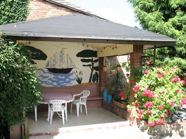 Flower, Plant, Property, Shade, Outdoor Furniture, Building, Outdoor Table, Chair, Table, Real Estate