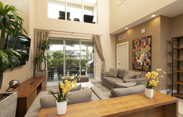Spacious living room with high ceilings and a smart TV for perfect ambiance.