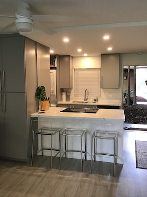 View of kitchen.  Pantry cabinet has microwave. 