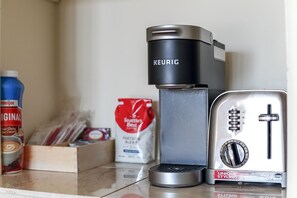 The unit is equipped with a Keurig coffee machine along with complimentary pods, providing an indulgent coffee experience.