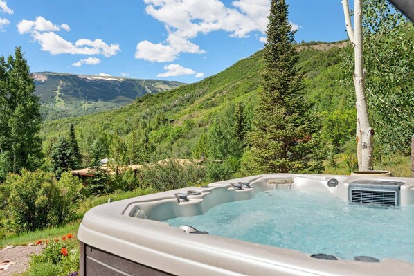 The Snowmass Mountain ski trails are visible from your private hot tub.