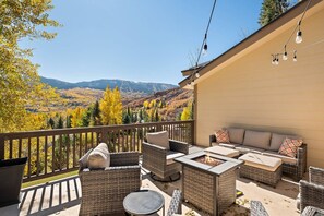 The deck of this home is a welcome spot year round with a gas fire pit, inviting furnishings and incredible views!