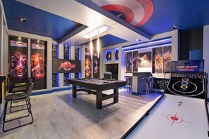 This man cave will never bore you, enter this extended happy place with a pool table and more.