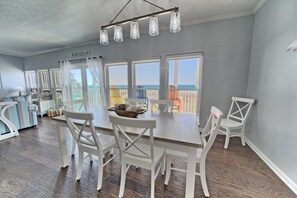 Gather for meals with loved ones at this charming dining table, complete with stunning ocean views to elevate every moment.