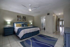 Spacious and comfy bedroom  with full AC, ensuite bath, king-sized bed, and flat screen TV.
