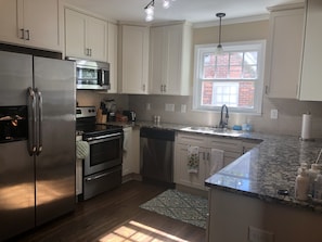 Kitchen has beautiful cabinets, granite counter tops and stainless appliances