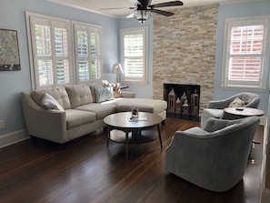 Beautiful light and bright living area with swivel chairs and large screen TV