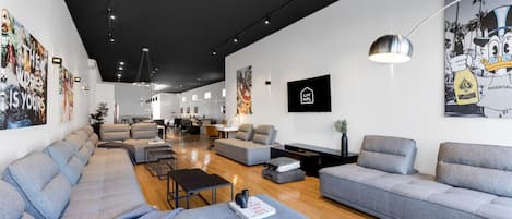 Living Room #1: Features 8 luxurious, brand-new full sofa beds, perfect for lounge group seating and providing ample sleeping space. Includes a Smart HD TV with Netflix, YouTube, and Prime Video.
