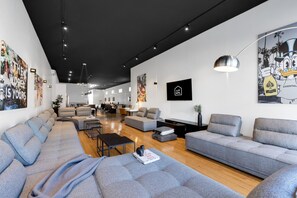 Living Room #1: Features 8 luxurious, brand-new full sofa beds, perfect for lounge group seating and providing ample sleeping space. Includes a Smart HD TV with Netflix, YouTube, and Prime Video.