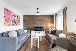 Living Room: Features 2 queen-size sofa beds, 1 queen air mattress, and a Smart HD TV. Log in to your favorite streaming services like Netflix, YouTube, and Prime Video.