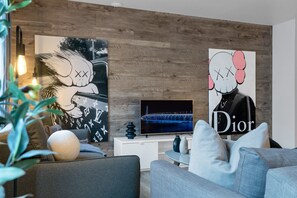 Living Room: Features 2 queen-size sofa beds with Art Deco, and a Smart HD TV with Netflix, YouTube, and Prime.