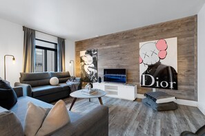Living Room: Features 2 queen-size sofa beds with Art Deco, and a Smart HD TV with Netflix, YouTube, and Prime.