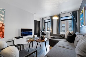 Living Room: Features queen-size sofa beds with Art Deco, and a Smart HD TV with Netflix, YouTube, and Prime.