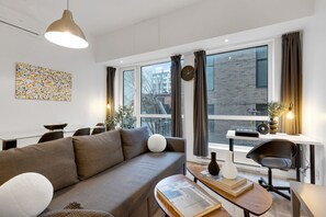 Living Room: Features 1 sofa bed, 1 queen-size bed with memory foam, Smart HD TV with Netflix, YouTube, and Prime.