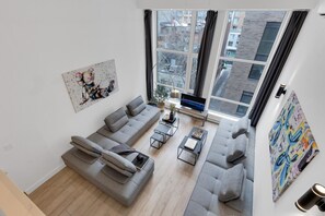 Living room: View from the mezzanine with 4 full sofa beds.