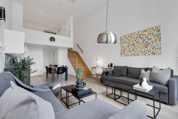 Living room: Features 2 queen sofa beds, 1 queen air mattress, and a Smart HD TV with access to Netflix, Disney+, and Prime.
