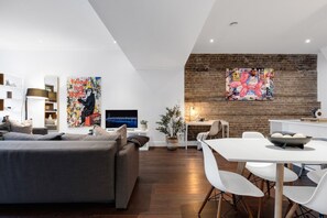 Living Room: Features 2 queen-size sofa beds with Art Deco, and a Smart HD TV with Netflix, YouTube, and Prime.