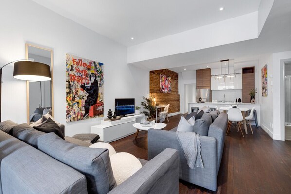 Living Room: Features 2 queen-size sofa beds with Art Deco, and a Smart HD TV with Netflix, YouTube, and Prime.