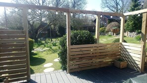 Decking looking out into garden, seating and gas BBQ provided