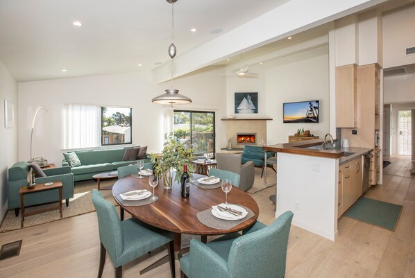 Fresh and bright dining area effortlessly bridges the gap between the kitchen and living spaces