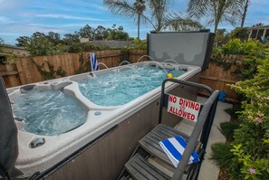 This home features a hot tub and swim pool combo, perfect for relaxing and exercising!