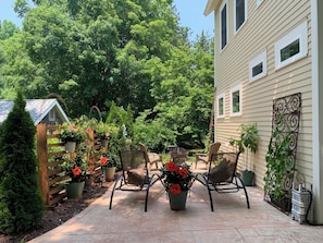 Patio with lounge chairs and fire pit. 