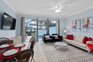 Living room that opens up to the pool and patio.