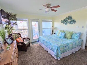 Master bedroom with lots of windows and views of the ocean.