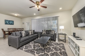 Spacious living room area and dining table with flat screen TV