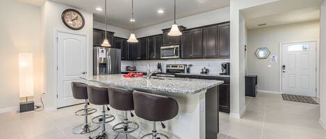 Beautiful modern style kitchen with pantry and barstool seating