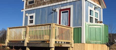 Front of the tiny house perched in its new spot atop a hill.