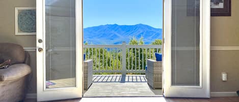 Incredible Summer view of Mt LeConte in Great Smoky Mountains National Park through the French doors in the living room of Mountainview Majesty.