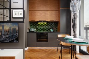 Kitchenette with oven and refrigerator. 