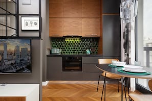 Kitchenette with oven and refrigerator.
