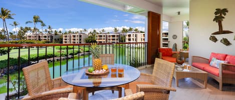 Welcome to paradise! This bright lanai offers an ideal spot for a cup of coffee.