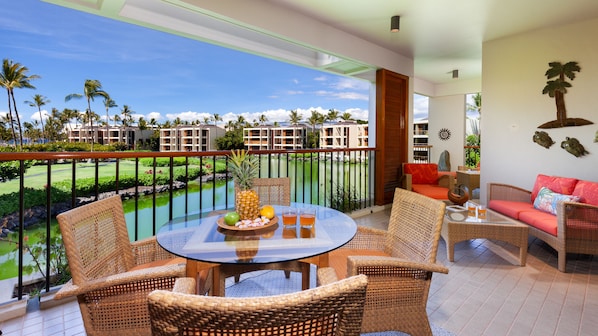 Welcome to paradise! This bright lanai offers an ideal spot for a cup of coffee.
