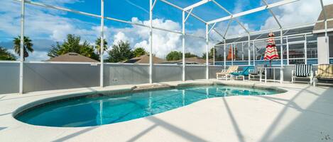 View of pool area.  Pool screen has opaque privacy panels