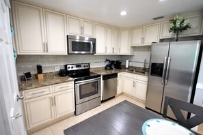 Well equipped kitchen added in 16'. Wood cabinets, granite, stainless appliances