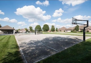 Community basketball court with adjustable goals. 