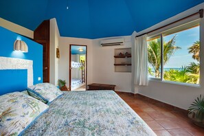 Room 1: Master bedroom with ocean view and two bunk beds for children.