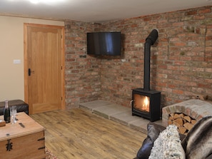 Living room with wood burner | The Old Forge, Baswick, near Driffield