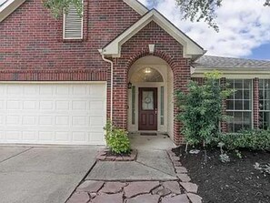 Extended driveway  leads a double car garage with automatic door.