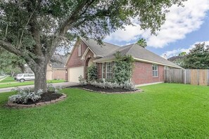This beautiful home sits on a perfectly landscaped corner lot.