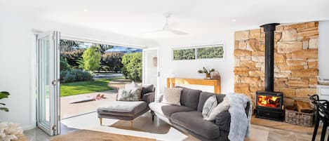 Living area with heated fire place and fold-able doors which open right up 